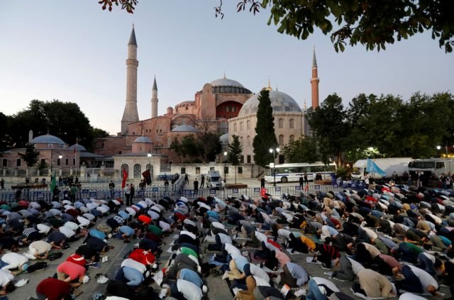 People gather in front of the Hagia Sophia or Ayasofya, after a court decision that paves the way for it to be converted from a museum back into a mosque, in Istanbul